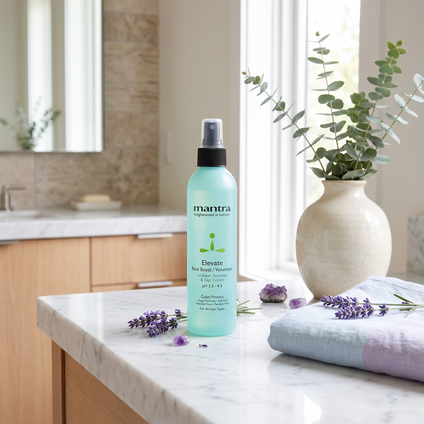 Mantra Elevate Root Boost Spray lifestyle scene on a marble bathroom counter
